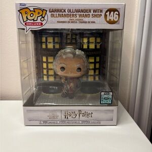 Funko Garrick Ollivander Deluxe Figure with Wand Shop Backdrop - Yellow & Black